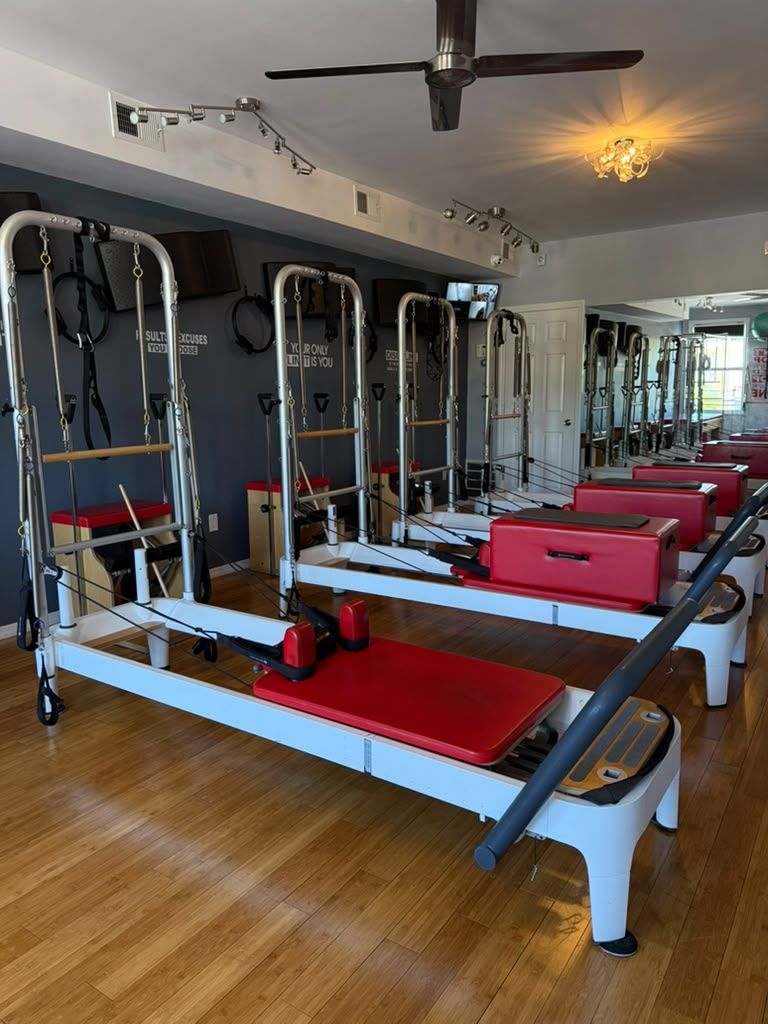 Reformers with towers lined up at BodyLine Pilates